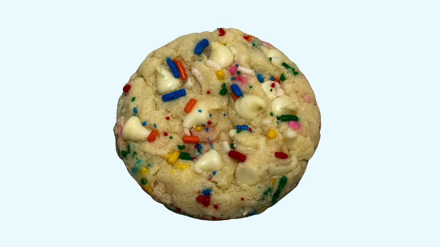 A gourmet confetti cake cookie, available for delivery. It has sprinkles and white chocolate chips.