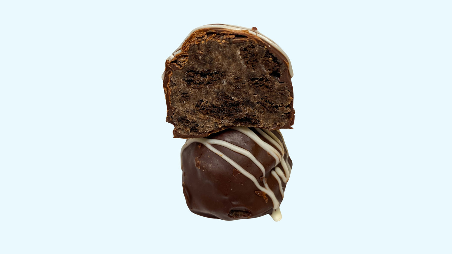 a gourmet giant stuffed truffle, with an oreo cheesecake filling and white chocolate drizzle on top.